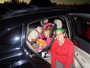 Liz and her family in the car ready for roatrip