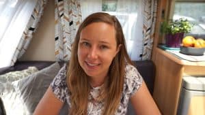 picture of Travelling K, a full-time RVer from New Zealand. She is in a camper wearing a t shirt.