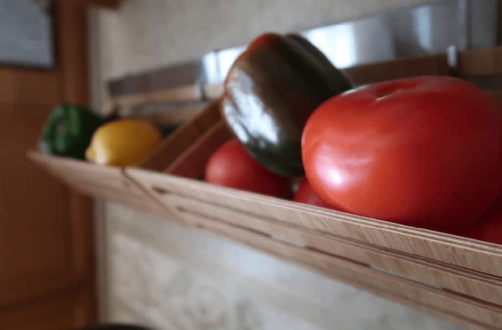 nice picture of hanging baskets above kitchen sink holding various vegetables