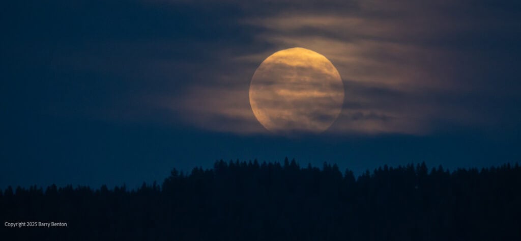 Moon shadowed by clouds
